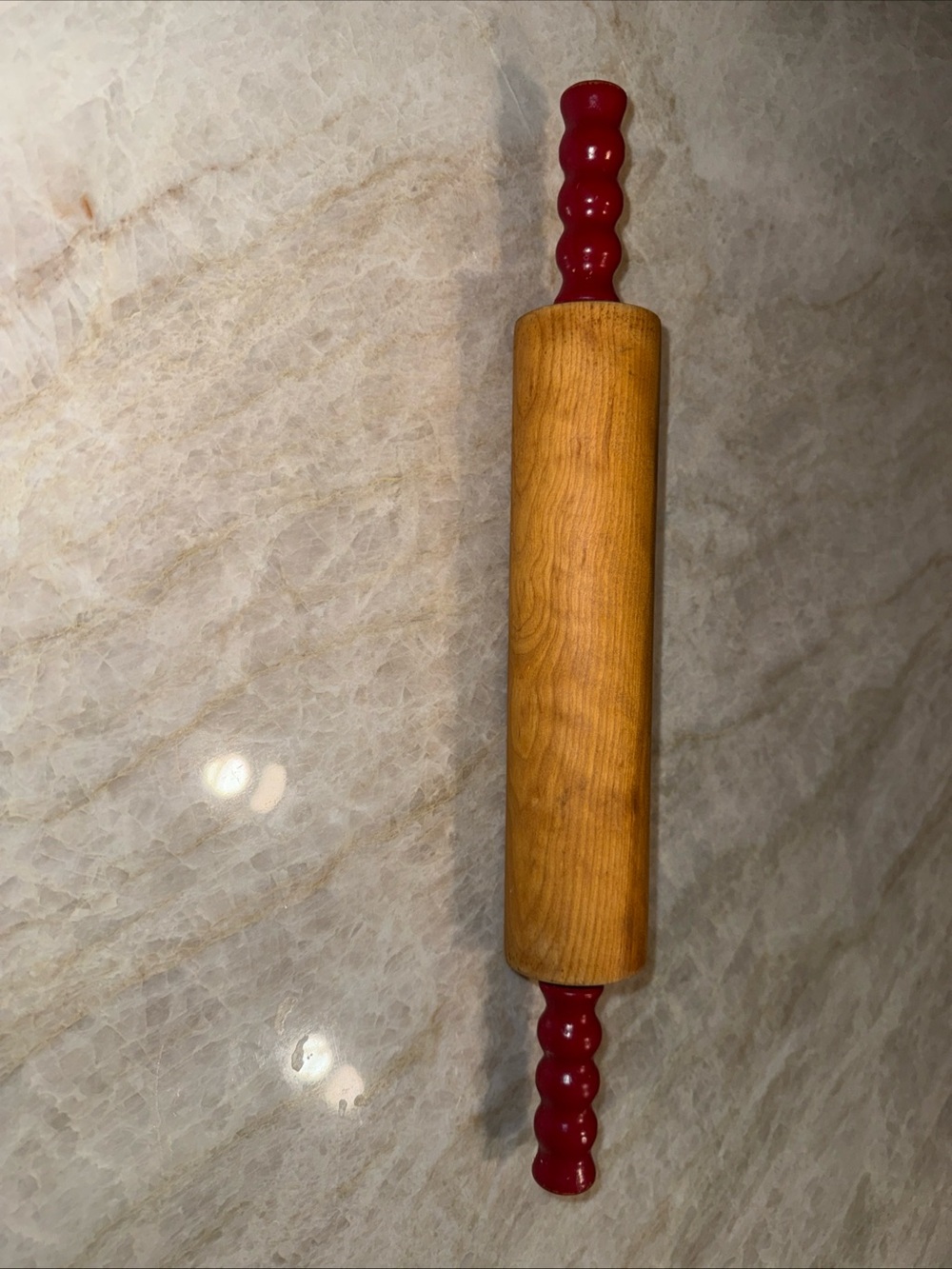 Vintage wooden rolling pin with red handles